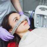 dentist puts inhalation sedative mask on his patient.