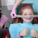 A little girl is comfortable to treat her teeth under superficial sedation.