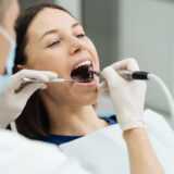 Endodontist applying endodontics procedures on a women