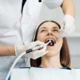 Overview of dental caries prevention, Girl at the dentist chair during a endodontic treatment